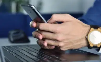 close up of man texting on phone utilizing healthy internet habits.