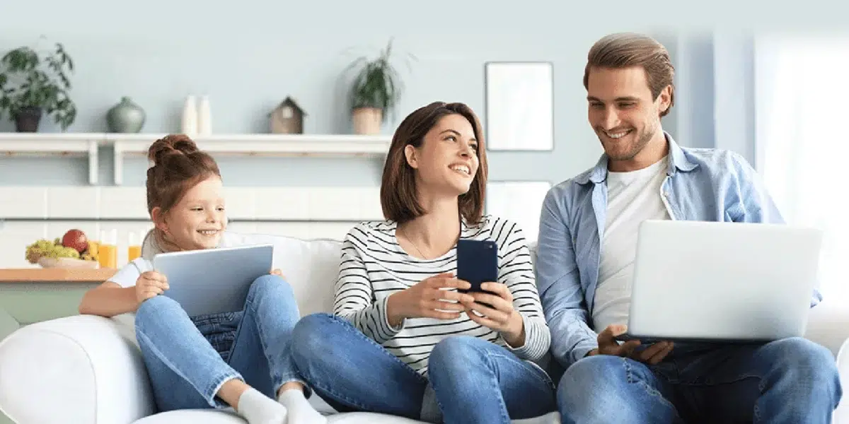 image of family using devices discussing the four benefits of fiber internet.