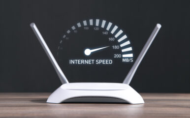 A modern WiFi router with a digital speedometer displaying internet speed, illustrating the question: how much internet speed do I need for optimal performance?