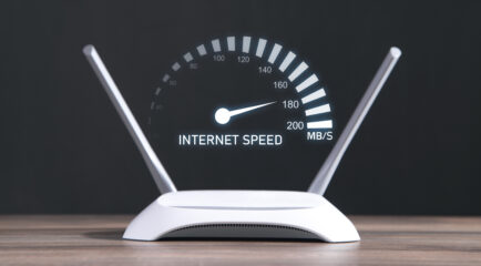 A modern WiFi router with a digital speedometer displaying internet speed, illustrating the question: how much internet speed do I need for optimal performance?