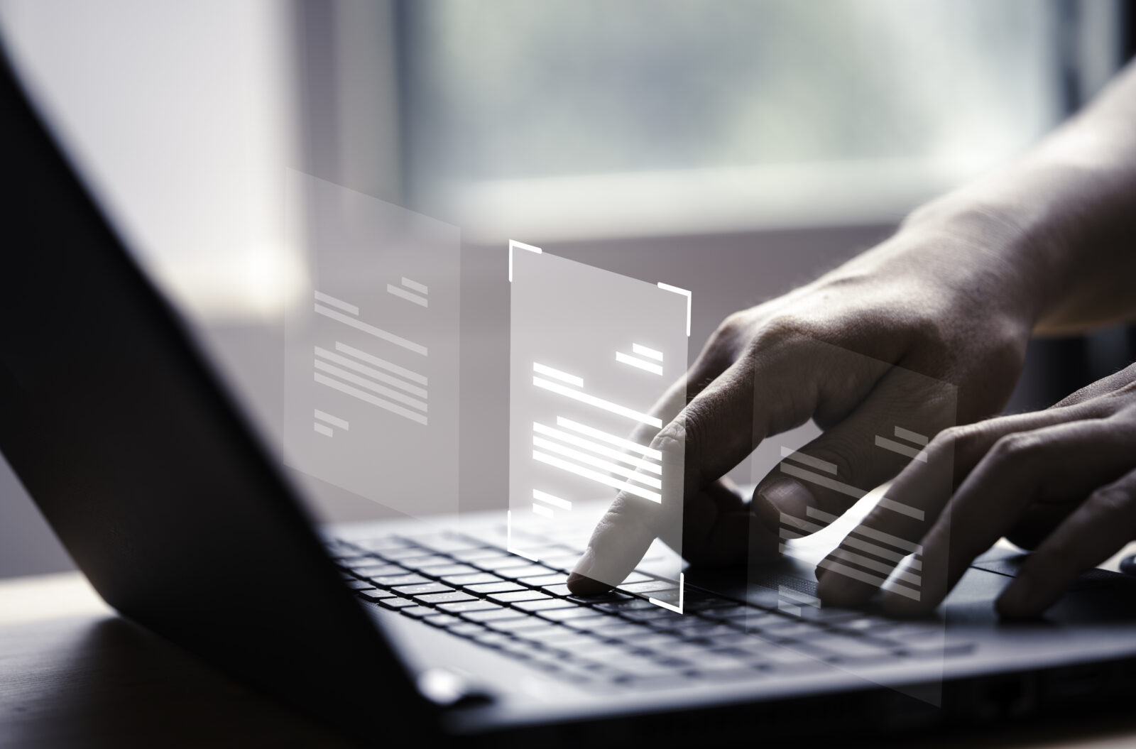 Close-up of a person using a laptop with digital documents displayed on the screen, illustrating the benefits of online file management in a discussion on fiber optic internet vs cable speeds and reliability.