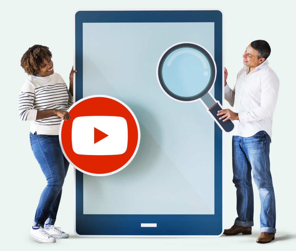 A smiling man and woman holding a large tablet with YouTube and magnifying glass icons, symbolizing video streaming and search on Google TV and YouTube.