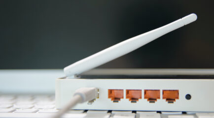 A router with visible Ethernet ports and an antenna, showcasing the concept of 